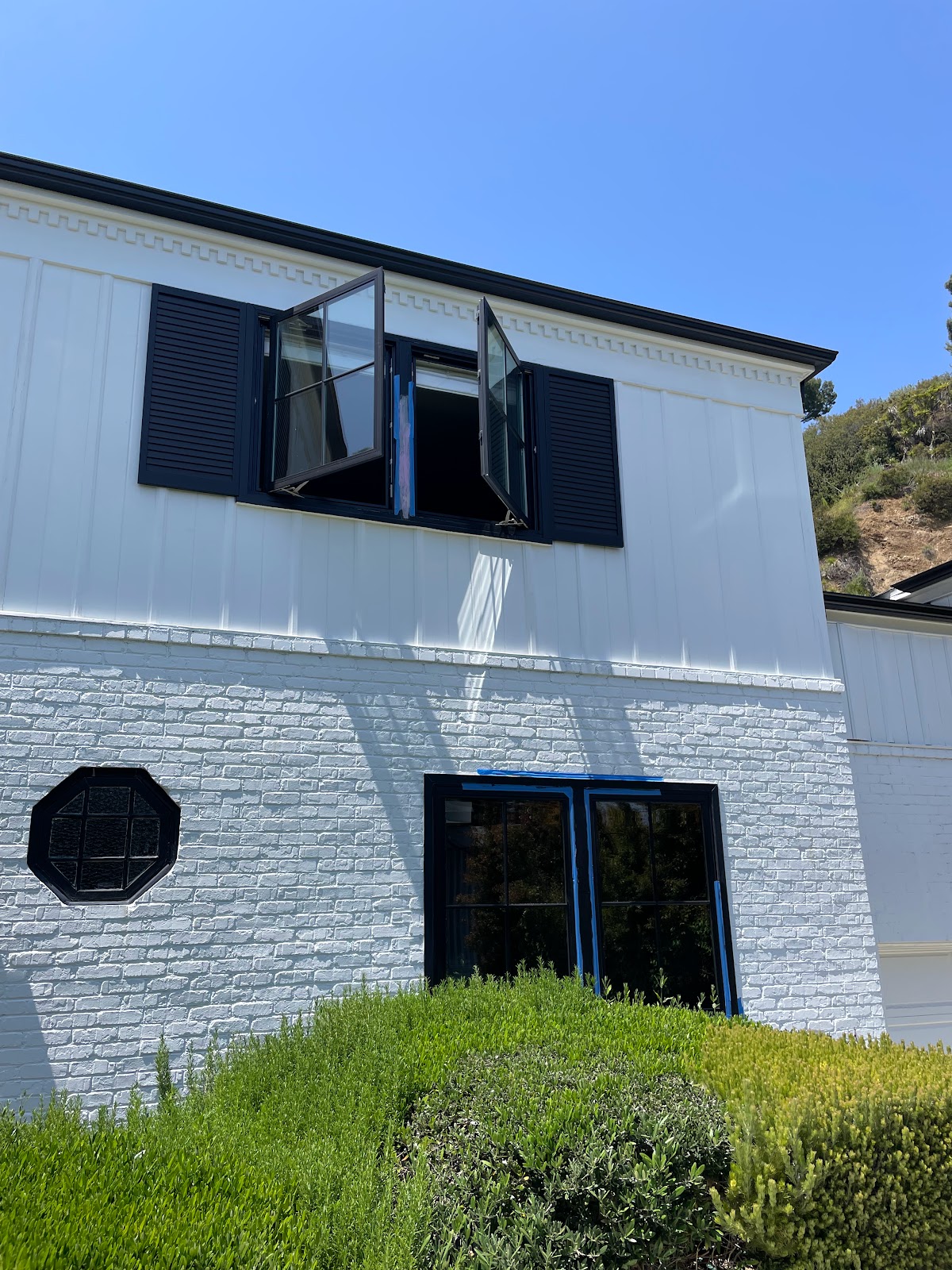 Beautifully painted residential exterior with crisp white and navy trim